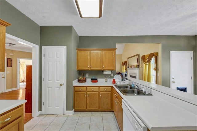 kitchen featuring dishwasher, light countertops, light tile patterned floors, a peninsula, and a sink