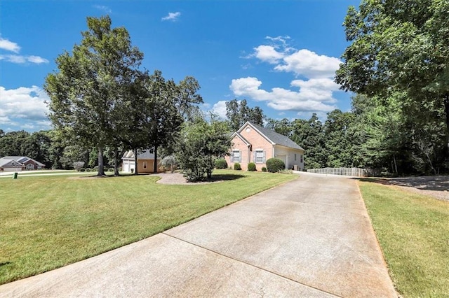 view of front of home with a garage and a front lawn