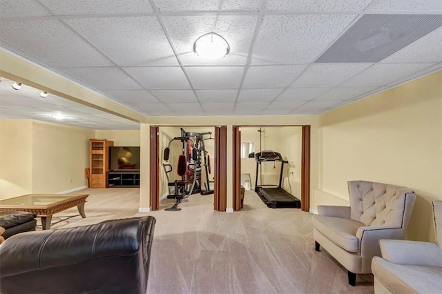 sitting room with a drop ceiling and carpet floors