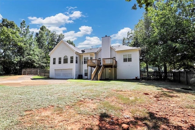 rear view of house featuring a chimney, concrete driveway, stairs, and fence