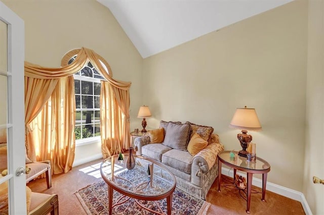 carpeted living area featuring baseboards and vaulted ceiling