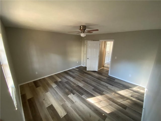 unfurnished bedroom featuring ceiling fan and dark hardwood / wood-style floors