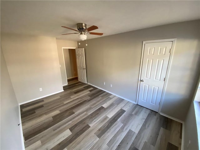 unfurnished bedroom featuring hardwood / wood-style floors and ceiling fan