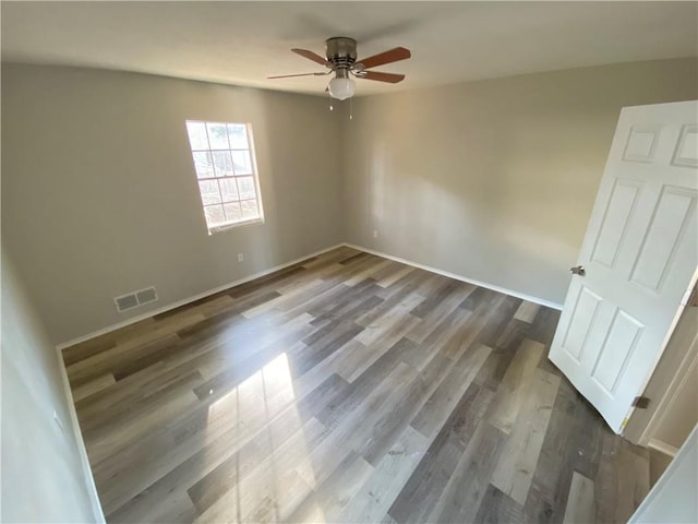 empty room featuring hardwood / wood-style floors and ceiling fan