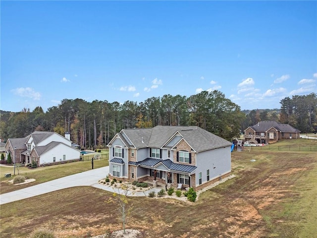 view of front facade with a garage, a front lawn, and covered porch