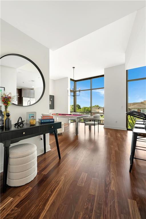 905 Juniper St NE Unit 805, Atlanta, GA 30309 - recreation room featuring wood finished floors, healthy amount of natural light, and floor to ceiling windows