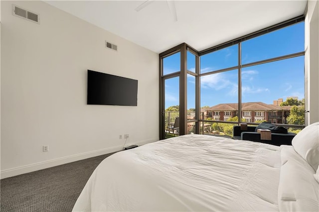 905 Juniper St NE Unit 805, Atlanta, GA 30309 - bedroom with a wall of windows, dark colored carpet, and a residential view