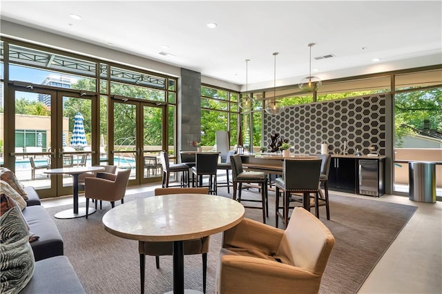 905 Juniper St NE Unit 805, Atlanta, GA 30309 - living room with french doors, healthy amount of natural light, beverage cooler, recessed lighting, and floor to ceiling windows
