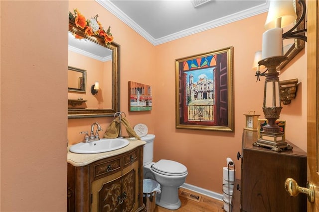 bathroom with hardwood / wood-style flooring, vanity, toilet, and crown molding