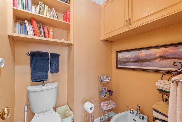 bathroom featuring toilet, built in features, and a bidet