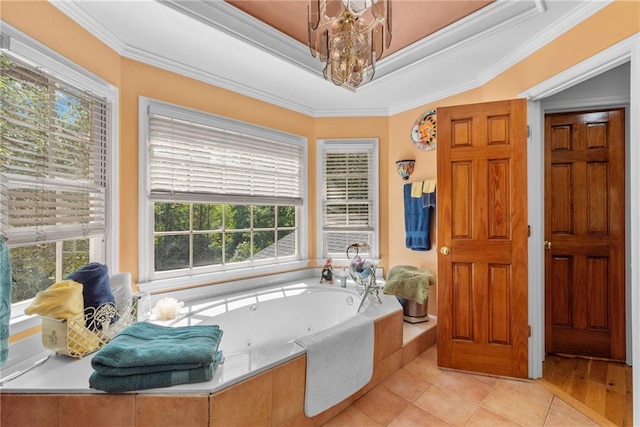 bathroom with a raised ceiling, tiled bath, tile patterned flooring, and ornamental molding