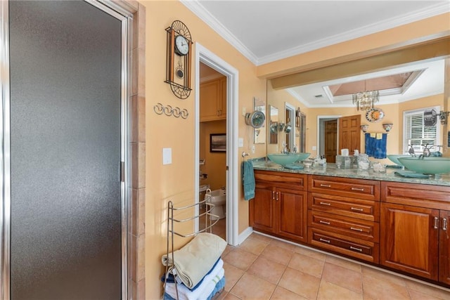 bathroom featuring tile patterned floors, vanity, crown molding, and a shower with shower door