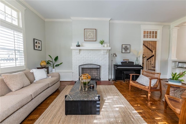 living room featuring crown molding, a brick fireplace, and dark parquet flooring