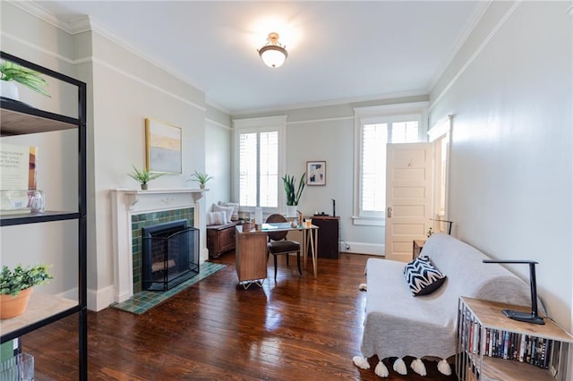 office space with ornamental molding, dark hardwood / wood-style flooring, and a tiled fireplace