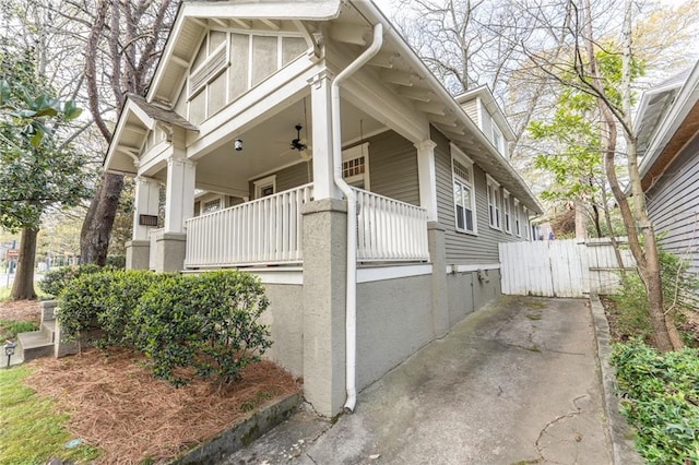 view of home's exterior featuring a balcony and ceiling fan