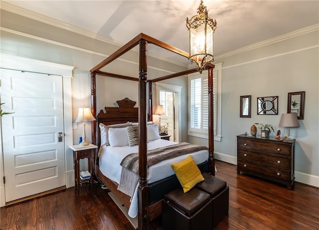 bedroom with a notable chandelier, dark hardwood / wood-style flooring, and ornamental molding