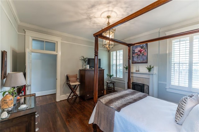 bedroom featuring a tiled fireplace, crown molding, and hardwood / wood-style floors