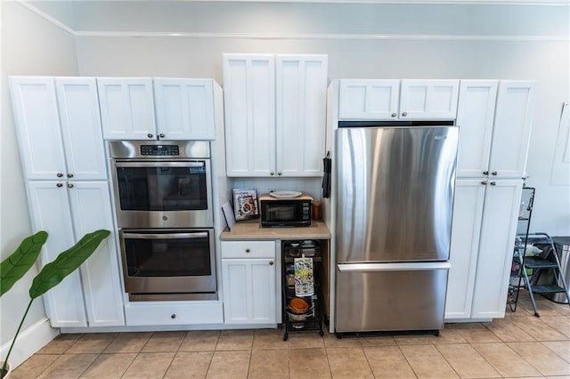 kitchen featuring appliances with stainless steel finishes and white cabinetry