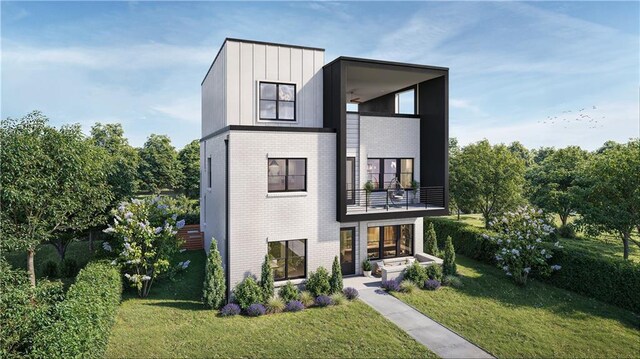 contemporary house with a front lawn and a balcony