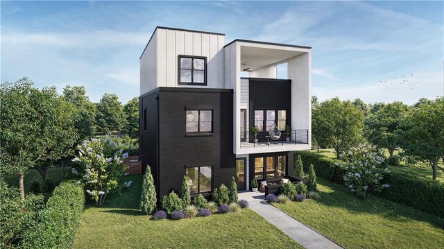 modern home featuring a balcony and a front lawn