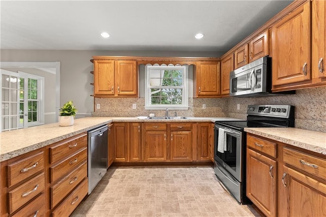 241 Cook St, Alto, GA 30510 - kitchen with appliances with stainless steel finishes, healthy amount of natural light, brown cabinetry, a sink, and recessed lighting