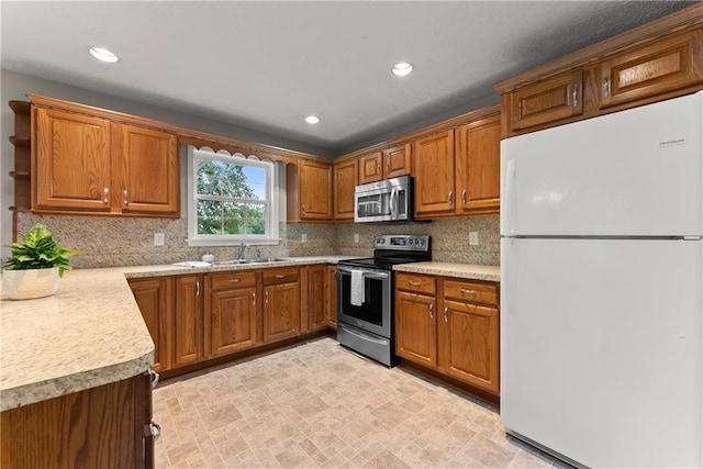 241 Cook St, Alto, GA 30510 - kitchen with appliances with stainless steel finishes, brown cabinets, a sink, light countertops, and recessed lighting