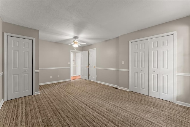 241 Cook St, Alto, GA 30510 - unfurnished bedroom featuring two closets, carpet, and baseboards