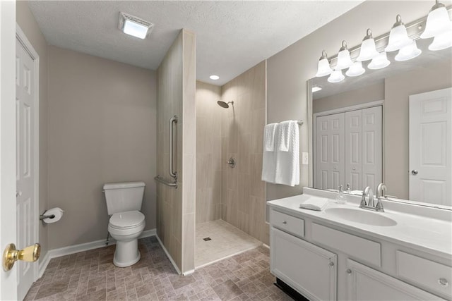 241 Cook St, Alto, GA 30510 - full bath with baseboards, toilet, a tile shower, vanity, and a textured ceiling