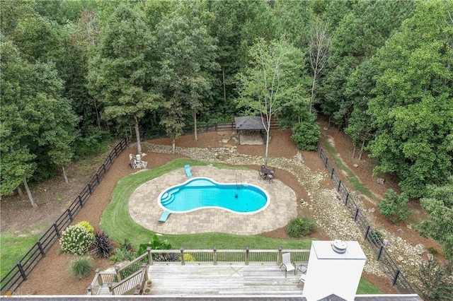 view of swimming pool with fence, a diving board, a fenced in pool, and a wooden deck