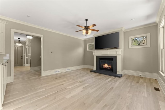 unfurnished living room featuring baseboards, a fireplace, a ceiling fan, and visible vents