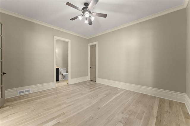 spare room with ceiling fan, visible vents, ornamental molding, and light wood-style floors