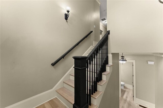 stairs with baseboards and wood finished floors