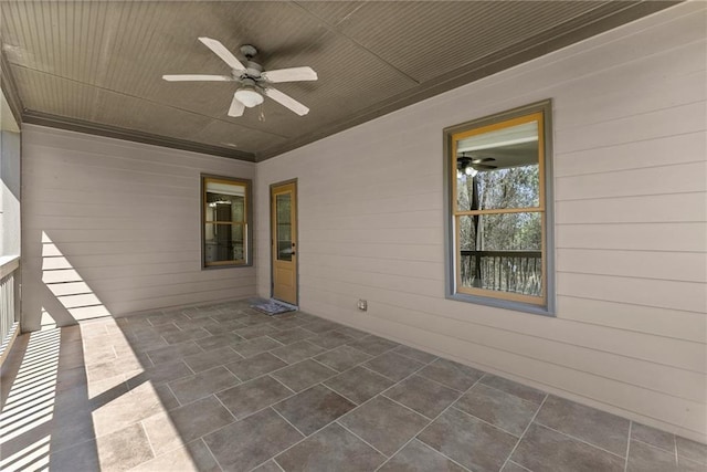 unfurnished sunroom featuring ceiling fan