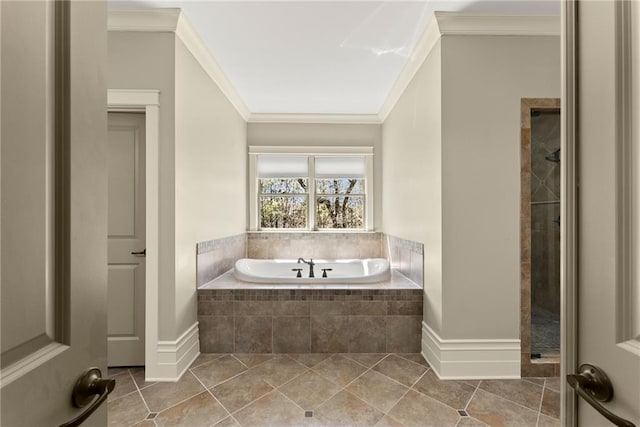 bathroom featuring tile patterned flooring, baseboards, ornamental molding, tiled shower, and a bath