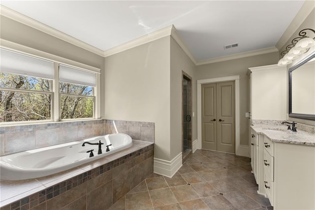 full bathroom with a garden tub, visible vents, crown molding, vanity, and tile patterned floors