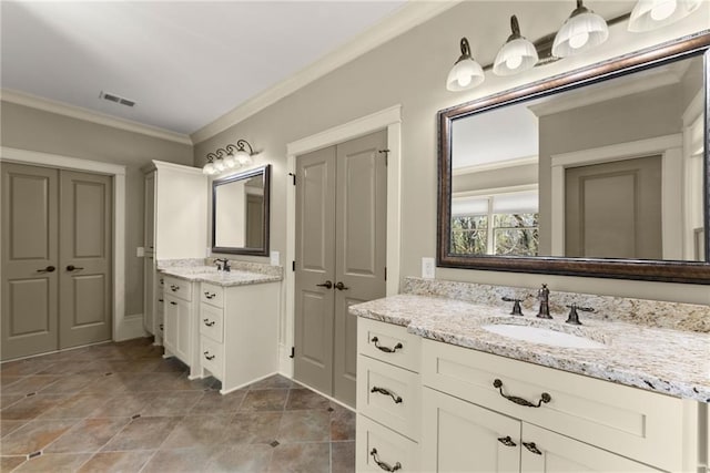 bathroom featuring a sink, ornamental molding, two vanities, and visible vents