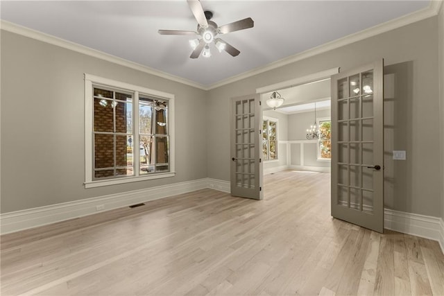 spare room featuring ornamental molding, french doors, wood finished floors, and visible vents