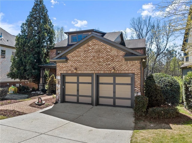 exterior space with concrete driveway, brick siding, an attached garage, and a shingled roof