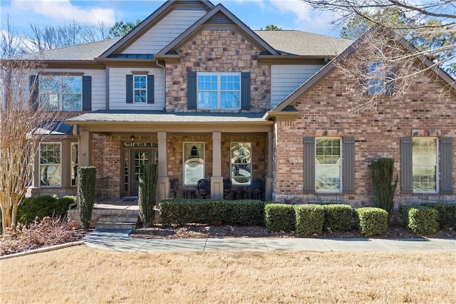 craftsman-style house with a porch and a front yard