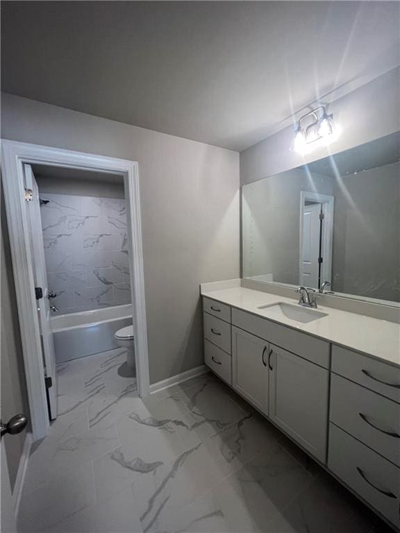 full bathroom with vanity, tiled shower / bath combo, and toilet