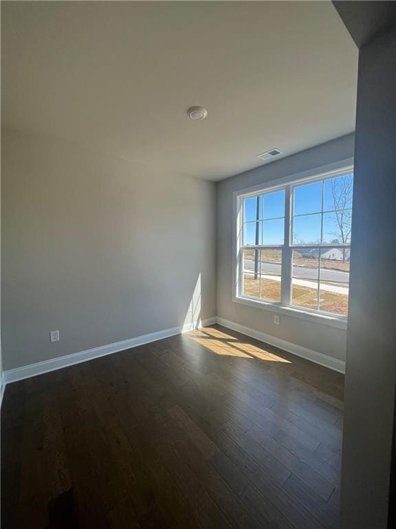 empty room featuring dark wood-type flooring