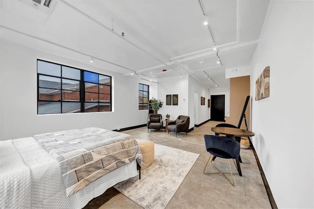 bedroom featuring rail lighting