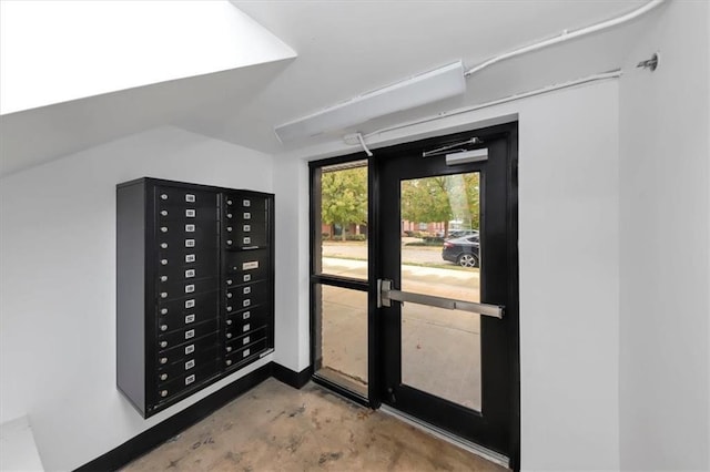 entryway with concrete flooring and mail boxes