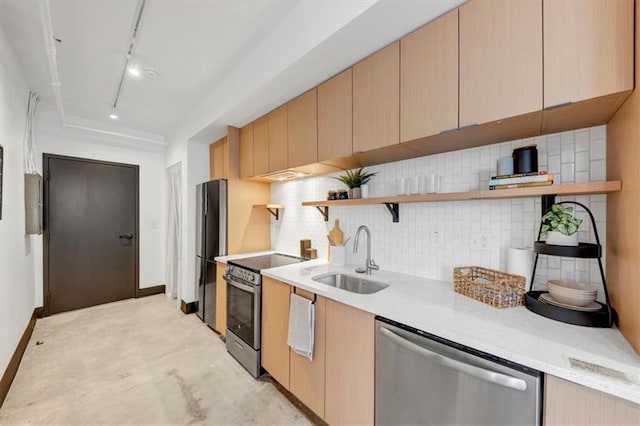 kitchen featuring sink, rail lighting, appliances with stainless steel finishes, tasteful backsplash, and light brown cabinetry