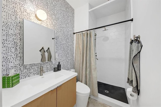 bathroom with walk in shower, vanity, toilet, and tasteful backsplash