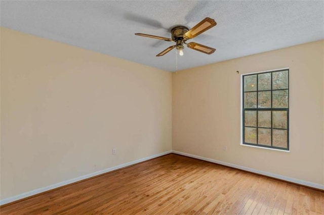 empty room featuring a textured ceiling, ceiling fan, and light hardwood / wood-style floors