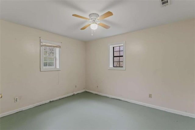 empty room featuring concrete flooring and ceiling fan