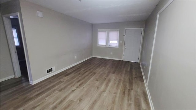 spare room with wood-type flooring