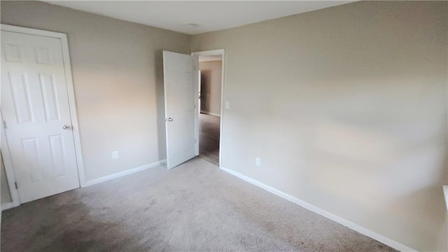 unfurnished bedroom with light colored carpet