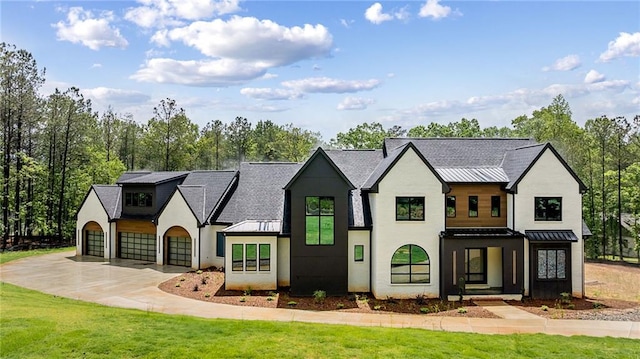 15154 Hopewell Rd, Alpharetta, GA 30004 - view of front of house with a standing seam roof, metal roof, concrete driveway, stucco siding, and a front yard